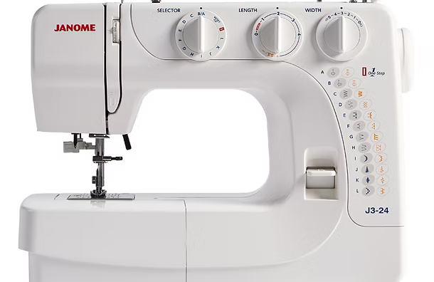 White Janome J3-24 sewing machine with stitch selection and width dials.
