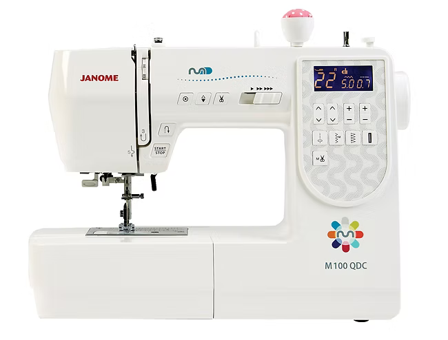 A white Janome M100QDC computerized sewing machine with a digital display and controls.