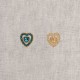 Two heart-shaped craft buttons, one with blue rhinestones and one gold.