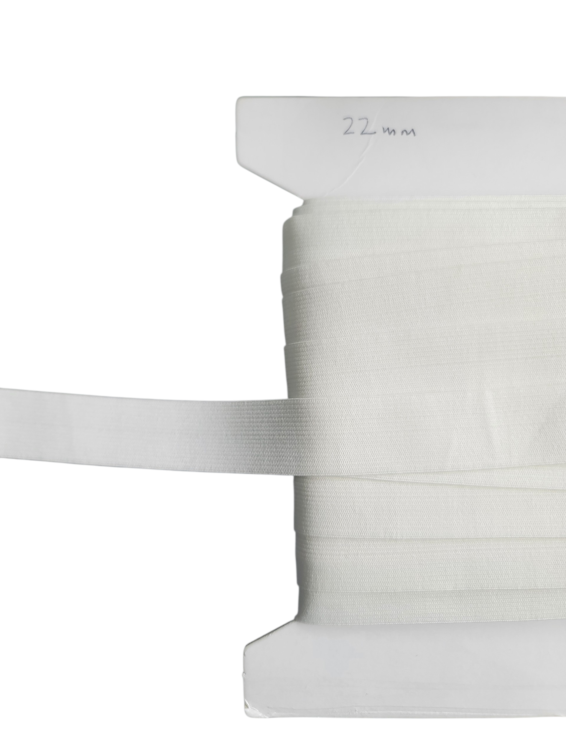 Soft white 22mm elastic ribbon wound around a white cardboard spool.