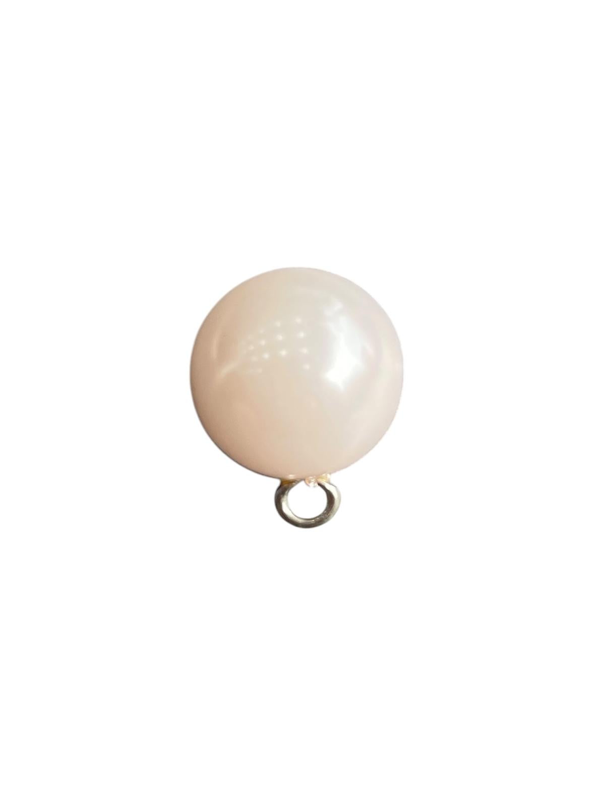 A single 15mm round white plastic pearl shank button for sewing.