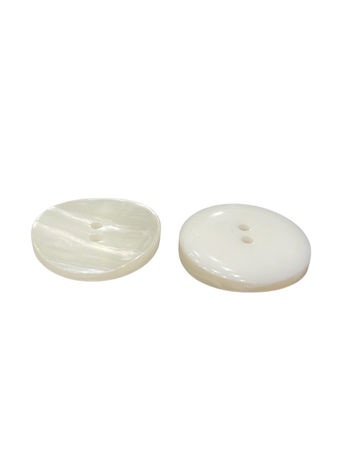 Two iridescent ivory shell-like sewing buttons with two holes and a slightly curved shape.