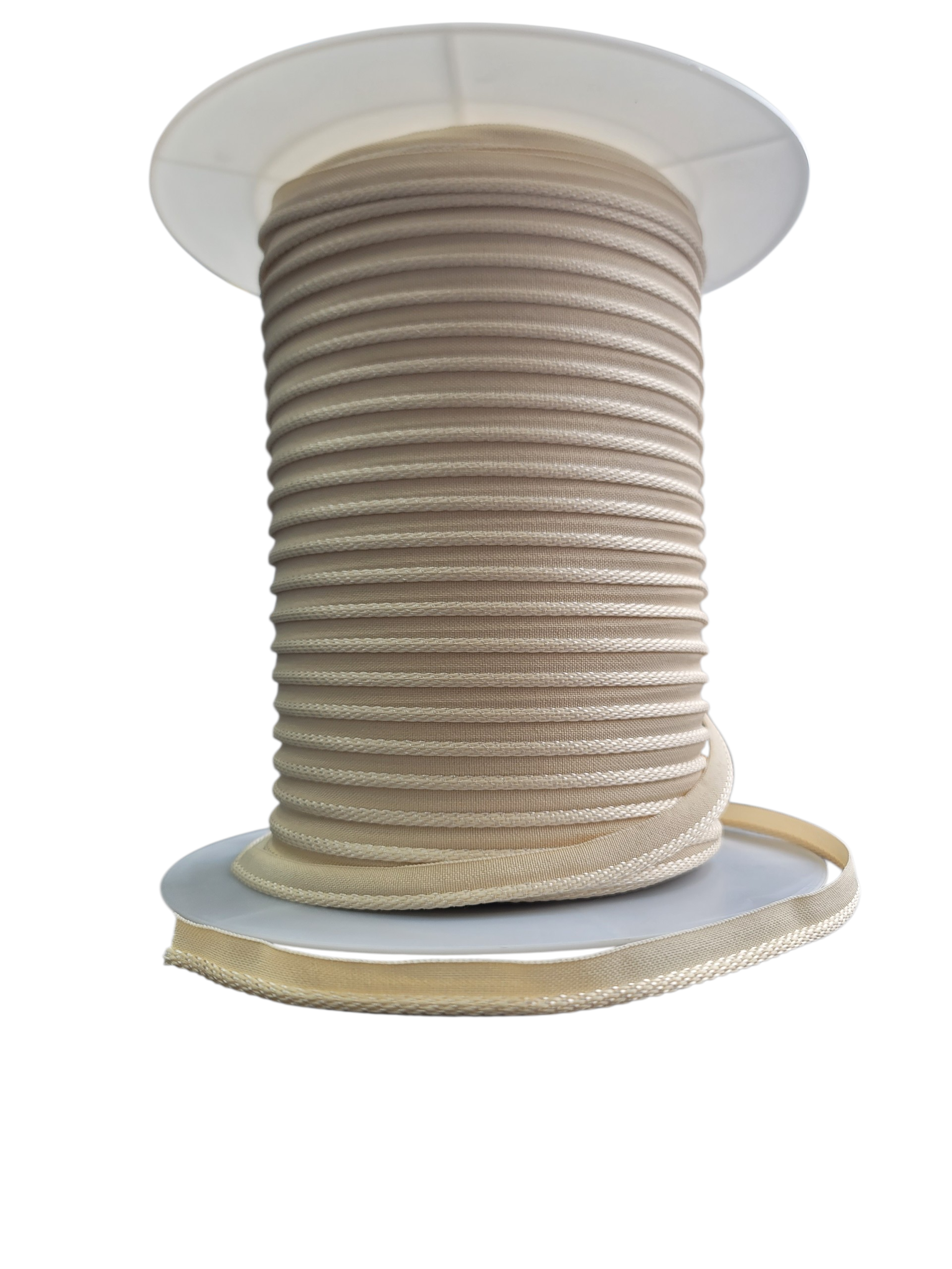A spool of cream-colored flanged cord for mattress and upholstery projects.