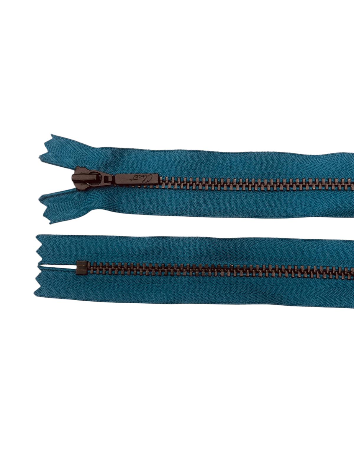 Two teal zippers with black metal teeth and sliders, one with a closed end.
