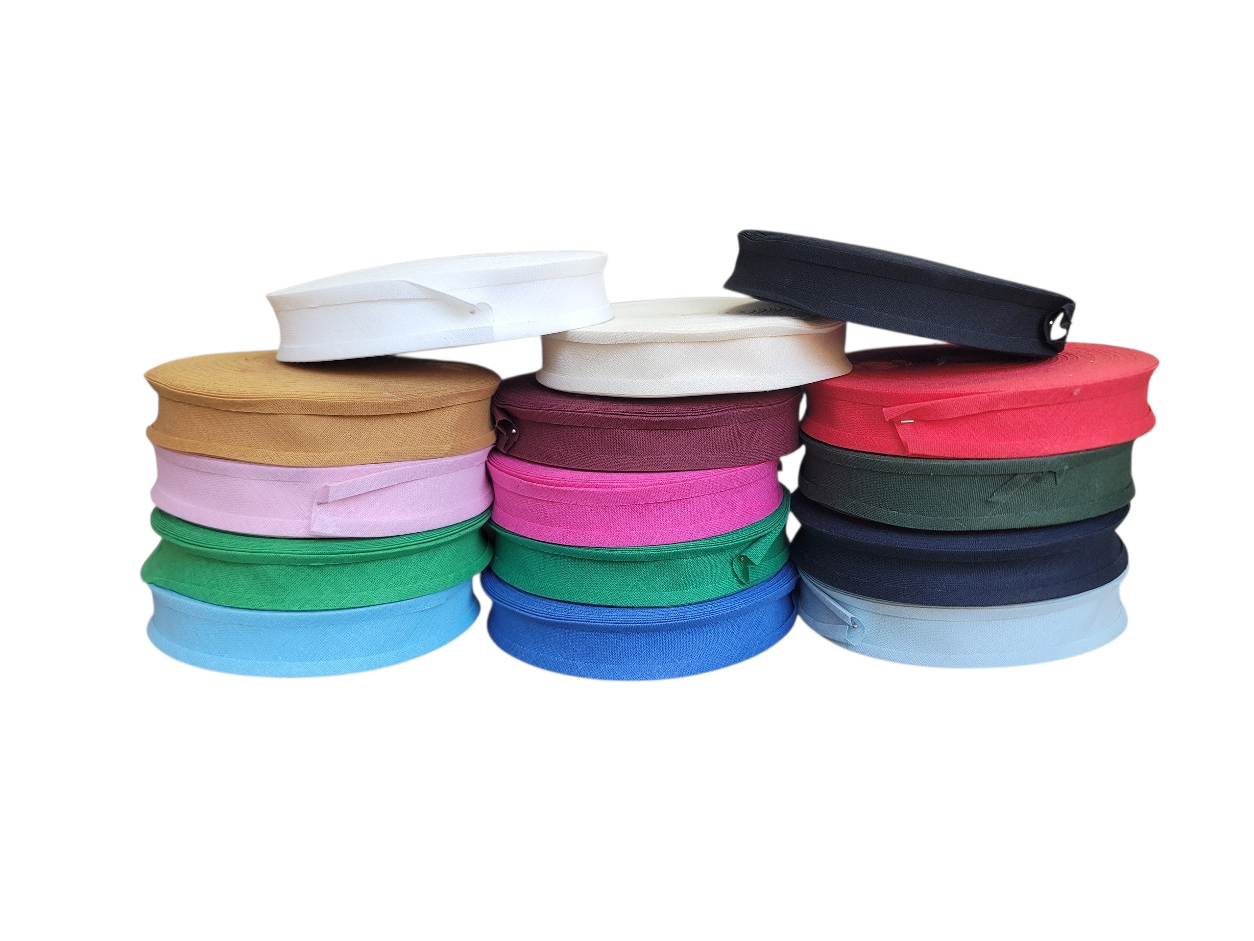 Multiple rolls of 25mm cotton bias binding in a variety of colors stacked in three columns.