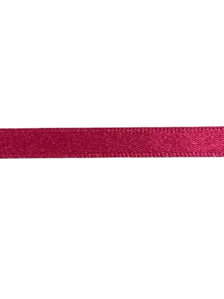 A single roll of 7mm wide magenta pink satin ribbon made of polyester fabric.