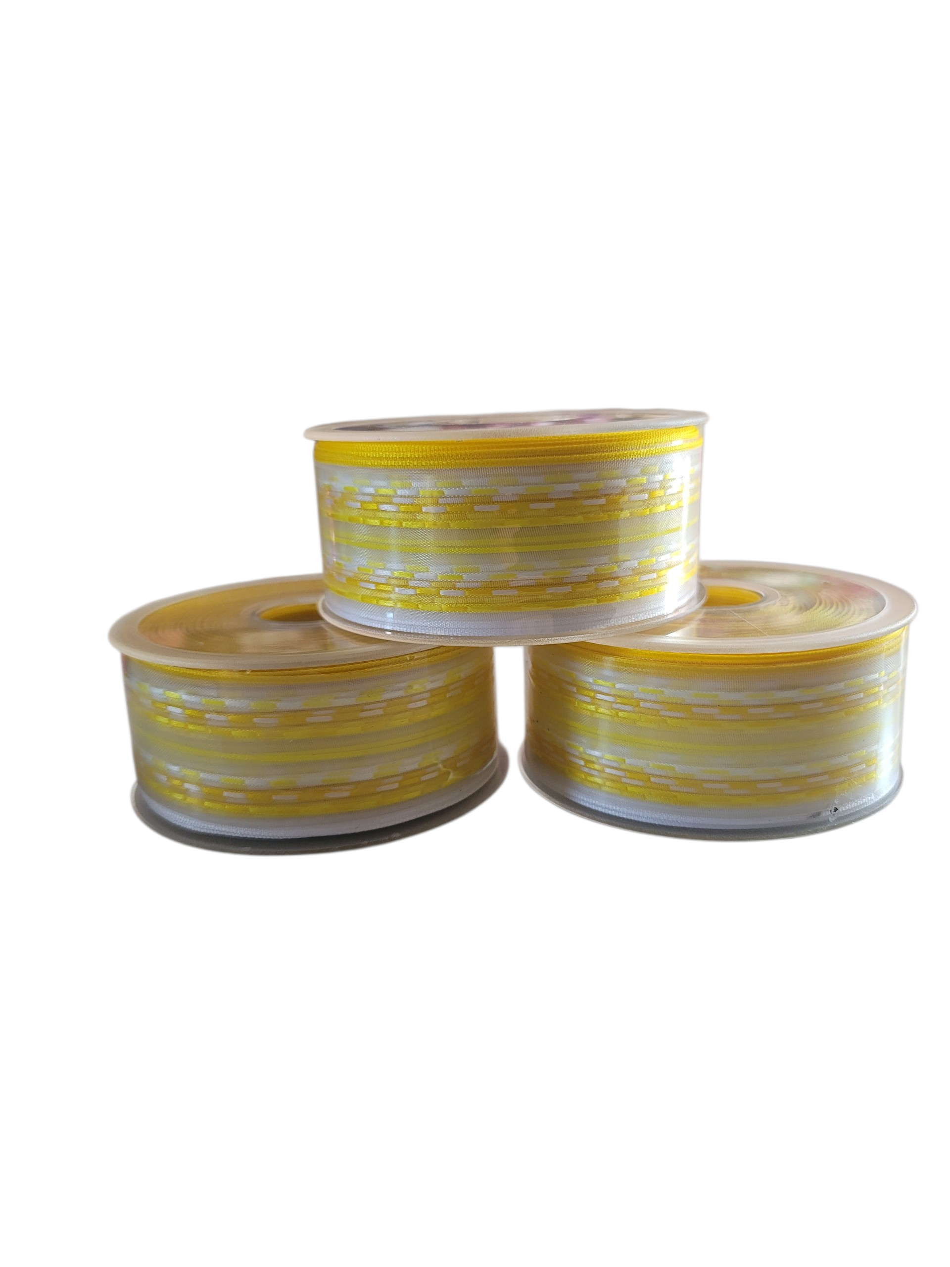 Three rolls of yellow and white chiffon ribbon tape stacked on a white background.