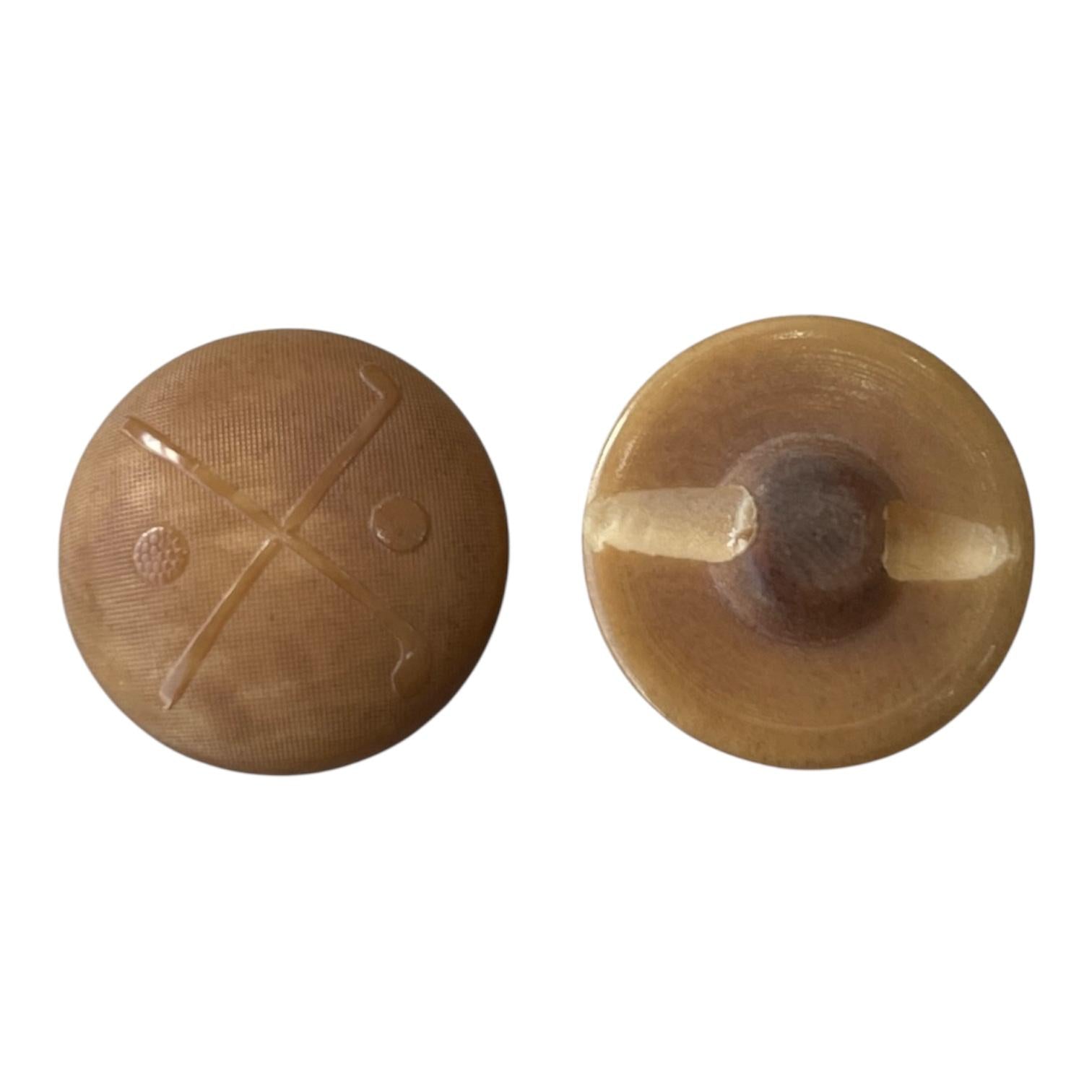 Front and back view of a 22mm brown polyester shank button featuring a crossed golf club design.