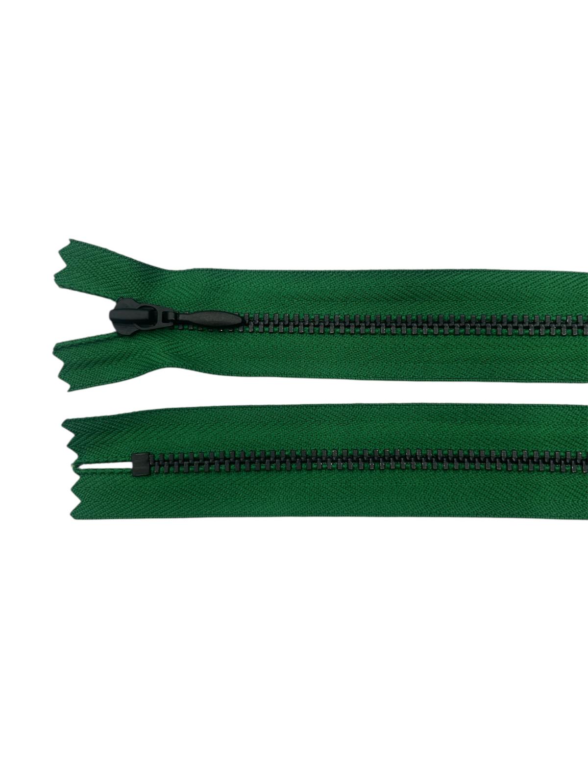 A dark green YKK closed-end zipper with black metal teeth and a black slider.