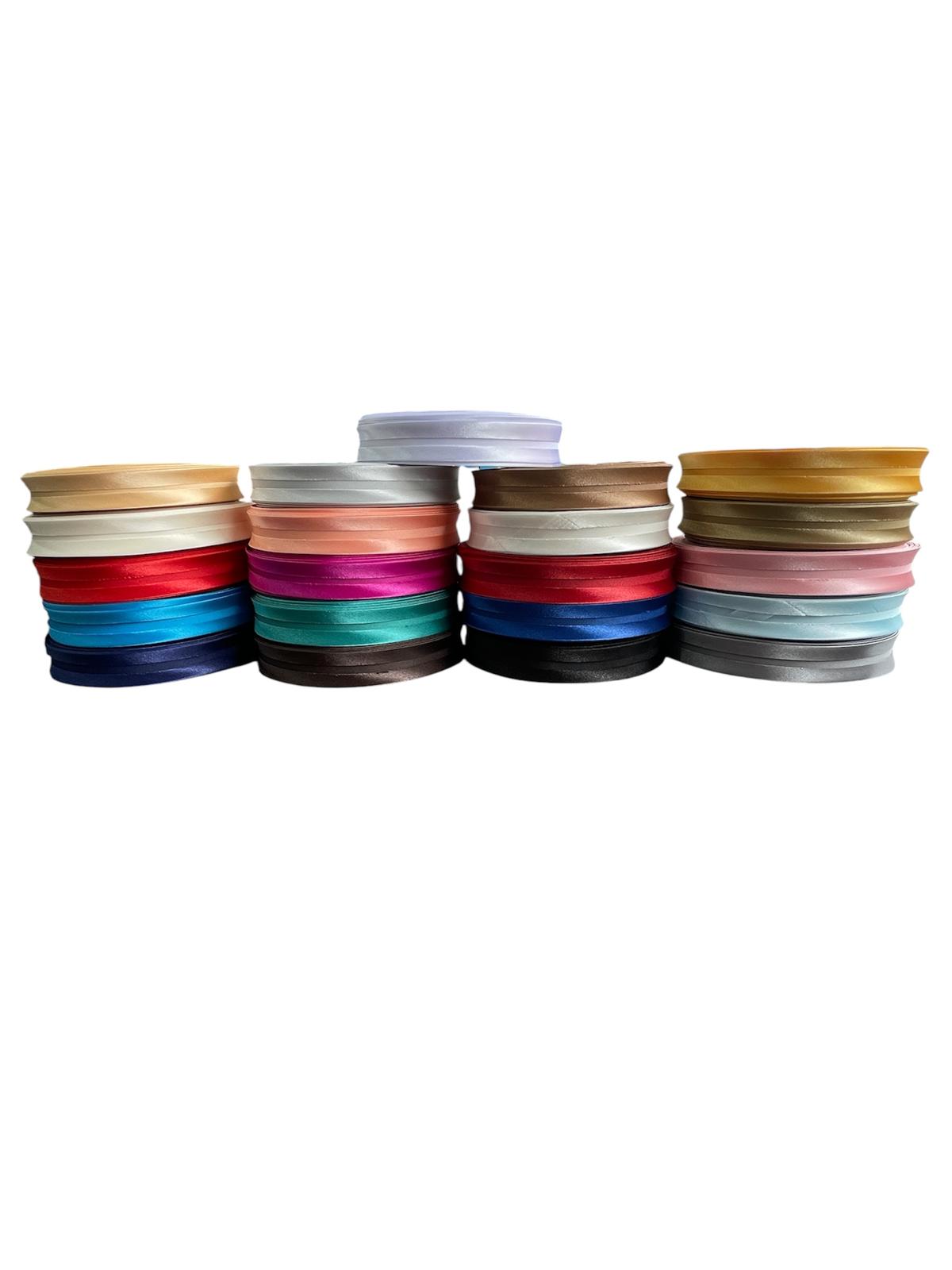 A variety of colorful satin bias binding tape rolls stacked in four columns on a white background.