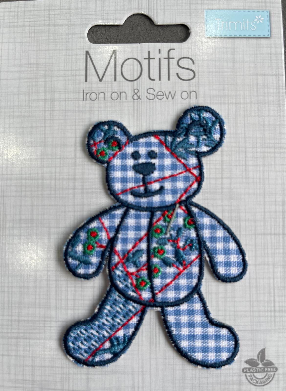Trimits blue patchwork bear iron-on motif with gingham patterns and red stitch details.