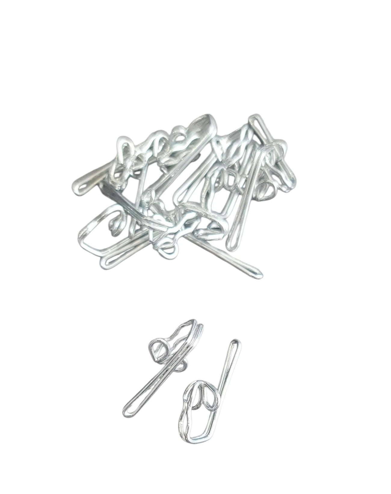 A pile and two individual silver zinc-plated metal curtain hooks for heading tapes and tracks.
