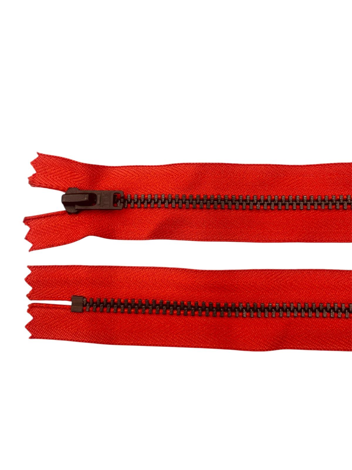 Two red YKK zippers with black metal teeth on a white background.