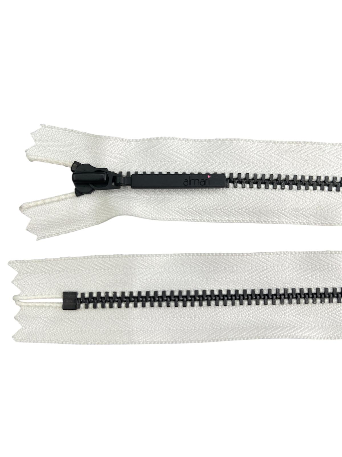 YKK size 3 black metal closed-end zipper with white tape.