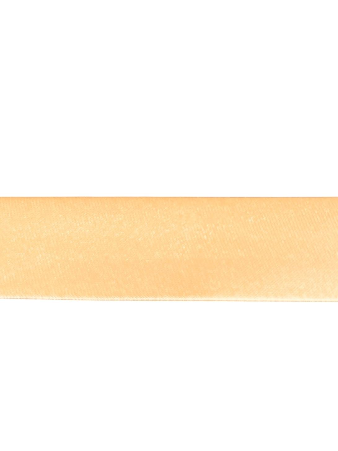 A close-up view of a single strip of light peach satin bias binding tape.