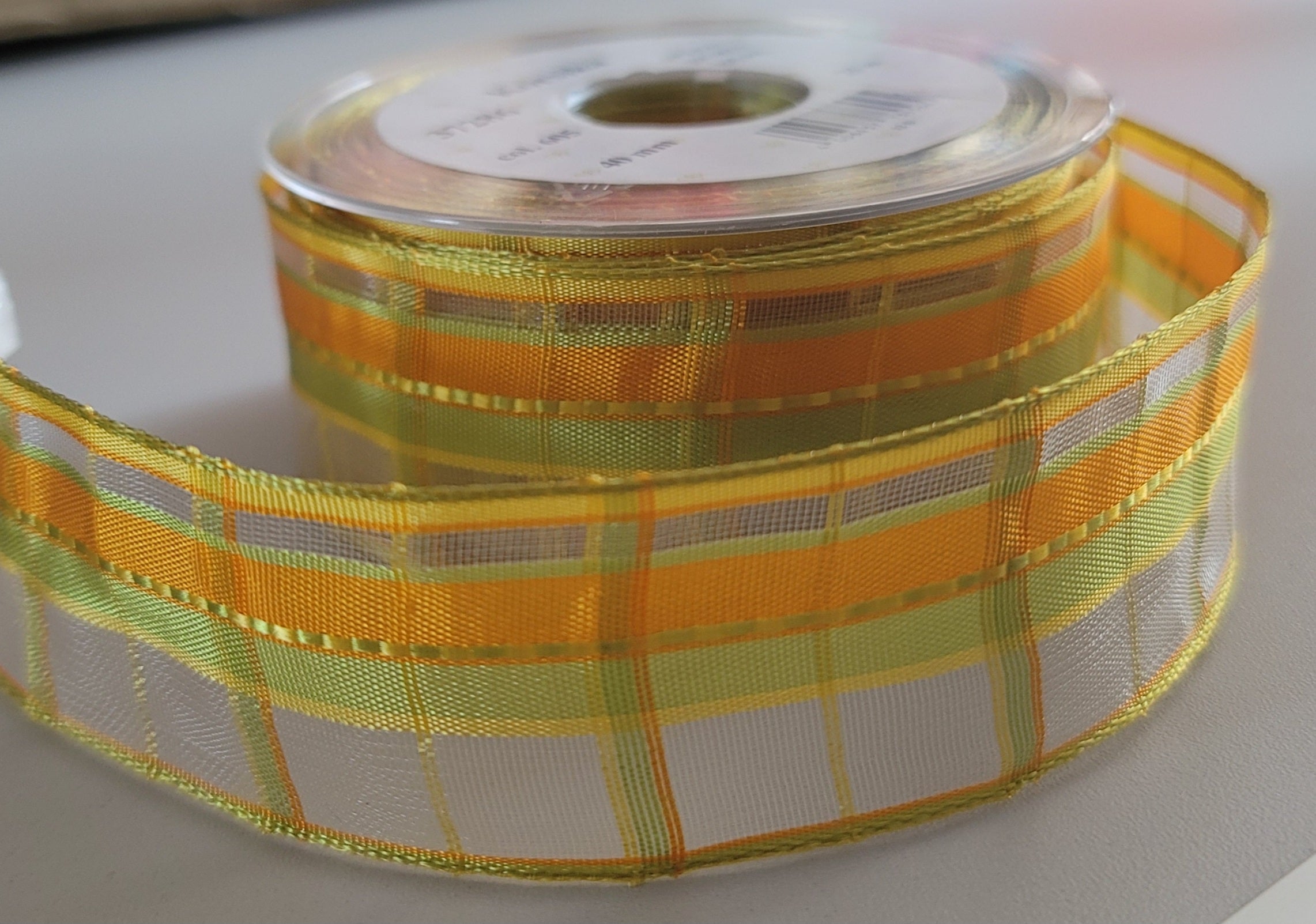 Korsika chiffon ribbon tape in an orange, yellow, and green plaid pattern on a 25-meter roll.